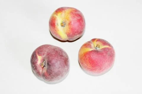 Peaches lying on the table on a white background Stock Photos