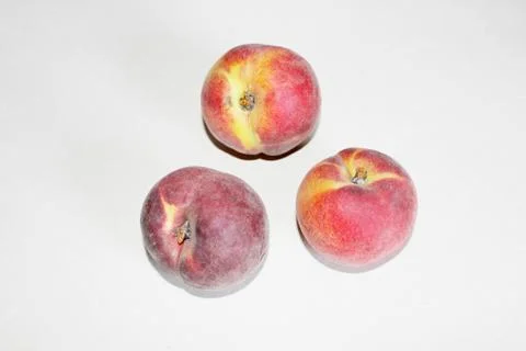 Peaches lying on the table on a white background Stock Photos