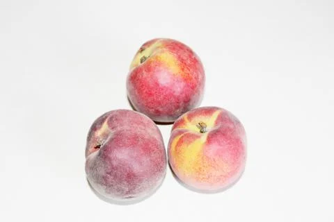 Peaches lying on the table on a white background Stock Photos
