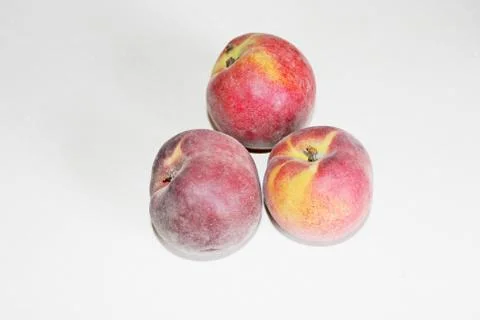 Peaches lying on the table on a white background Stock Photos