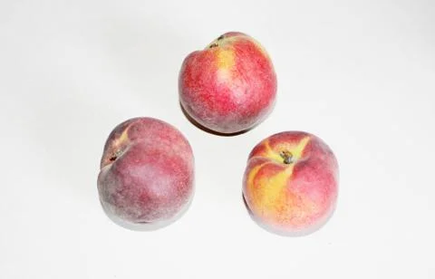 Peaches lying on the table on a white background Stock Photos
