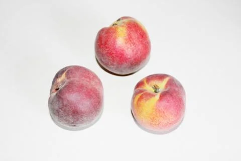 Peaches lying on the table on a white background Stock Photos