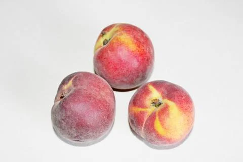 Peaches lying on the table on a white background Stock Photos