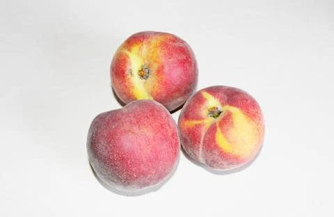 Peaches lying on the table on a white background Stock Photos