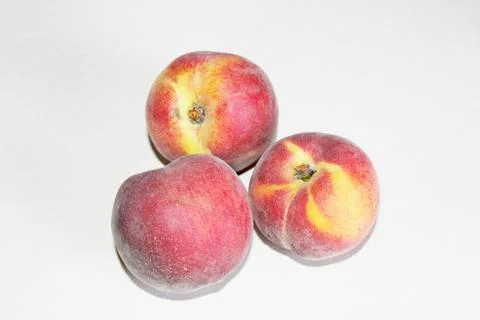 Peaches lying on the table on a white background Stock Photos