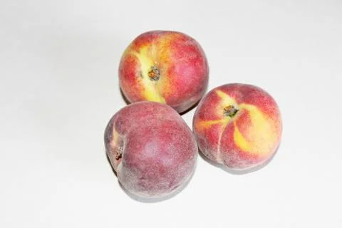 Peaches lying on the table on a white background Stock Photos