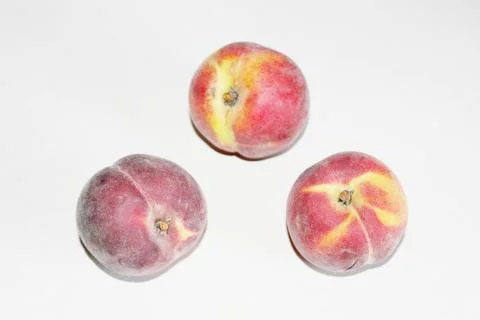 Peaches lying on the table on a white background Stock Photos
