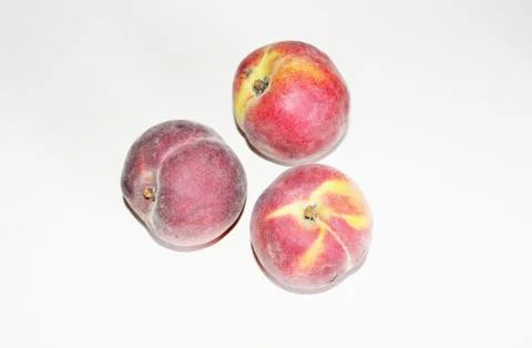Peaches lying on the table on a white background Stock Photos