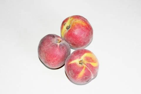 Peaches lying on the table on a white background Stock Photos