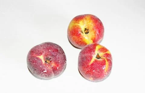 Peaches lying on the table on a white background Stock Photos
