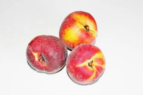 Peaches lying on the table on a white background Stock Photos