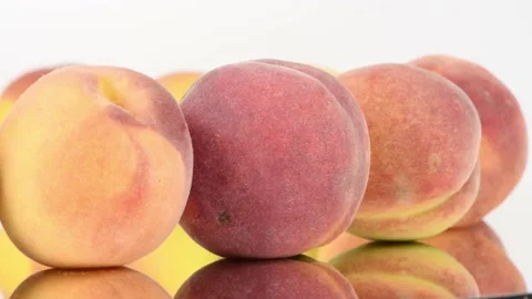Peaches in a row on mirror. Rotation with acceleration. Side view. Stock Footage 161242897