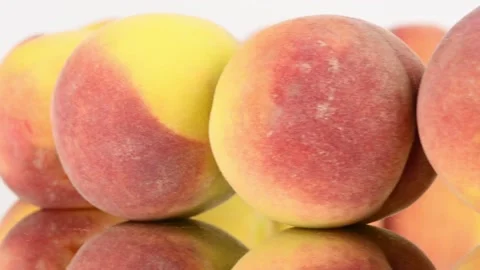 Peaches in a row on mirror. Rotation with acceleration. Stock Footage 161243286