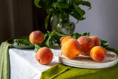 Peaches on table in kitchen near window. Rustic minimalism food peach fruits Stock Photos