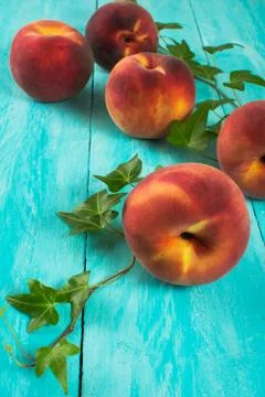 Peaches on turquoise table Stock Photos