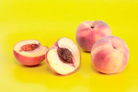 Peaches on yellow Stock Photos
