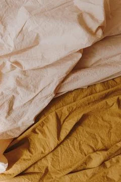 Peachy beige and ginger bed linen cloth. Crumpled blanket, textile pattern 写真素材