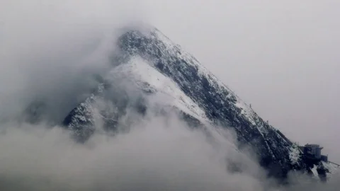 Peak in the alps sheathed with clouds Stock Footage 84468704