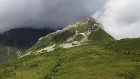 A peak of the alps wrapped in a cloud Stock Footage 138881376