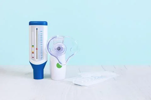 Peak flow meter, mesh nebulizer and nebulas. Copy spase. Stock Photos