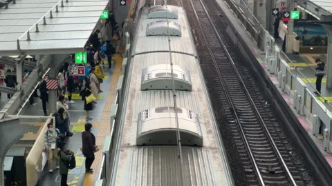 Peak hour train arriving with commuters disembarking. Stock Footage 250499191