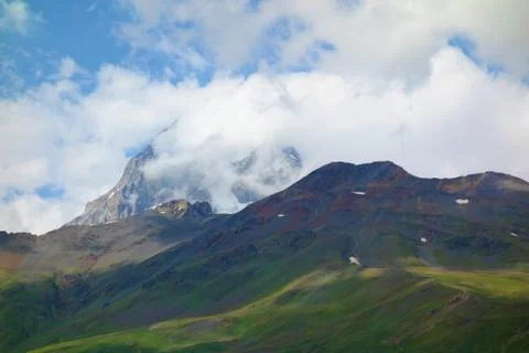Peak of mount Ushba covered in clouds in Caucasus mountains, Upper Svaneti re Stock Photos
