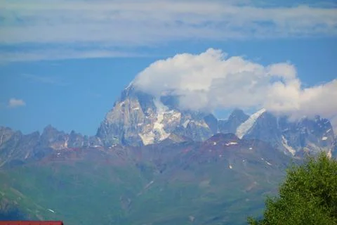 Peak of mount Ushba covered in clouds in Caucasus mountains, Upper Svaneti re Stock Photos