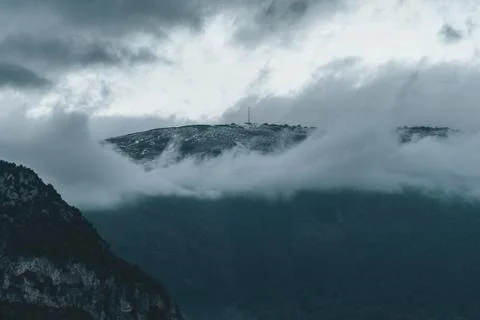 The peak of the mountain appears over clouds in Pyrenees Stock Photos