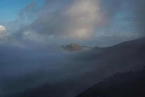 Peak of the mountain between the clouds in the evening 写真素材