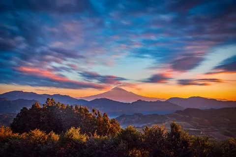 The peak of Mt. Fuji on dramatic sky at sunrise in Shizuoka, Japan. Stock Photos
