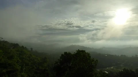 Peak Reflections: Aerial Odyssey of Cloud-covered Mountains in 4K Stock Footage 244472479