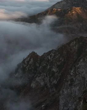 Peak rocks in thick clouds at sunset in autumn Fotos de archivo