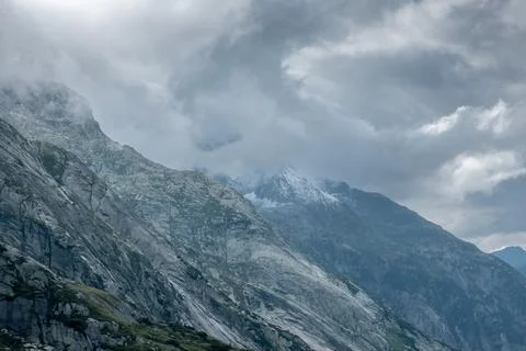 Peaks getting hidden by the clouds in the Alps Stock Photos