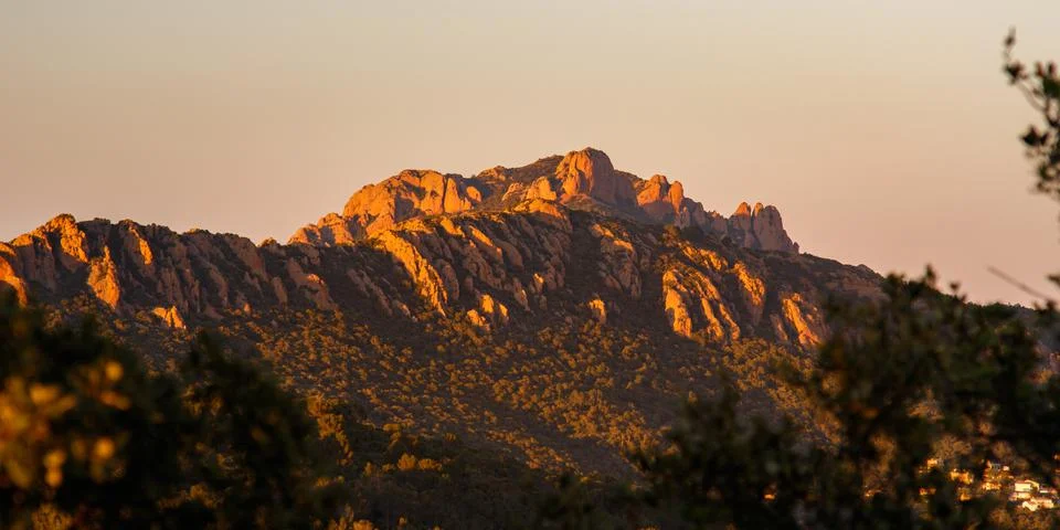Peaks of a mountain range at sunset or sunrise Stock Photos