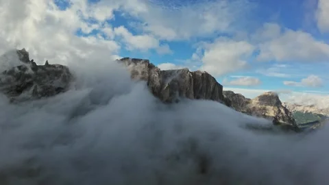 Peaks piercing through thick sea of clouds, summit panorama unfolds; dramatic Stock Footage 323890648