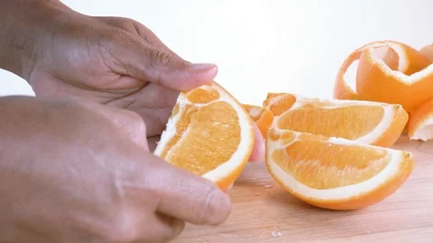 Pealing orange’ quarters with bare hands Stock Footage 124444785