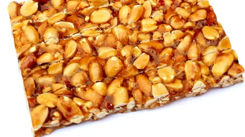 Peanut brittle isolated on white background Vídeo Stock 32503120