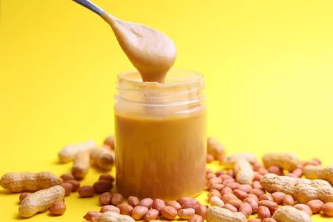 Peanut butter on a colored background Stock Photos