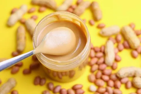 Peanut butter on a colored background Stock Photos