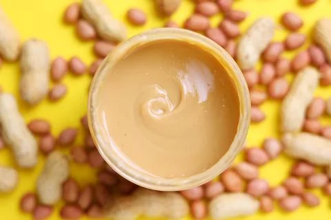 Peanut butter on a colored background Stock Photos