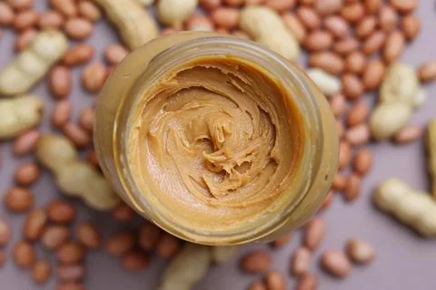 Peanut butter on a colored background Stock Photos