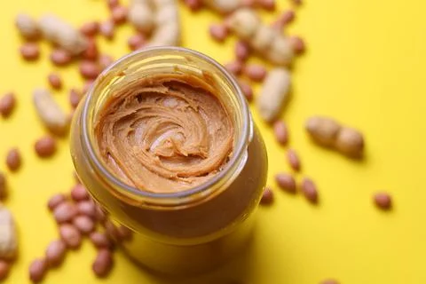 Peanut butter on a colored background Stock Photos