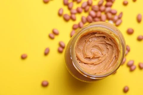 Peanut butter on a colored background Stock Photos