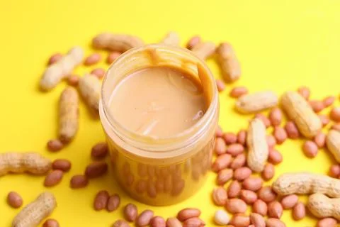 Peanut butter on a colored background Stock Photos