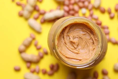 Peanut butter on a colored background Stock Photos