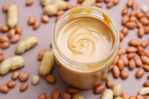 Peanut butter on a colored background Stock Photos