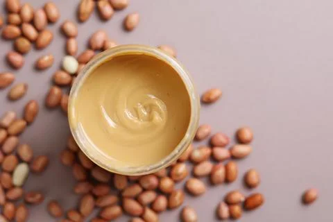Peanut butter on a colored background Stock Photos