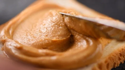 Peanut butter. Person making peanut butter sandwiches, healthy food Stock Footage 106162353