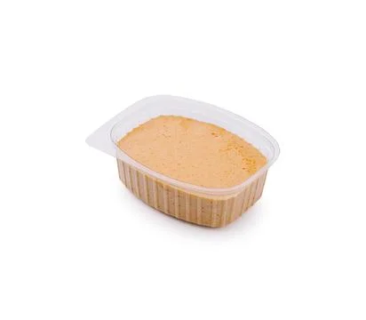 Peanut butter in a plastic container ready for spreading on bread Stock Photos