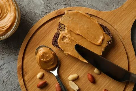 Peanut butter spread on bread with nuts and honey Stock Photos